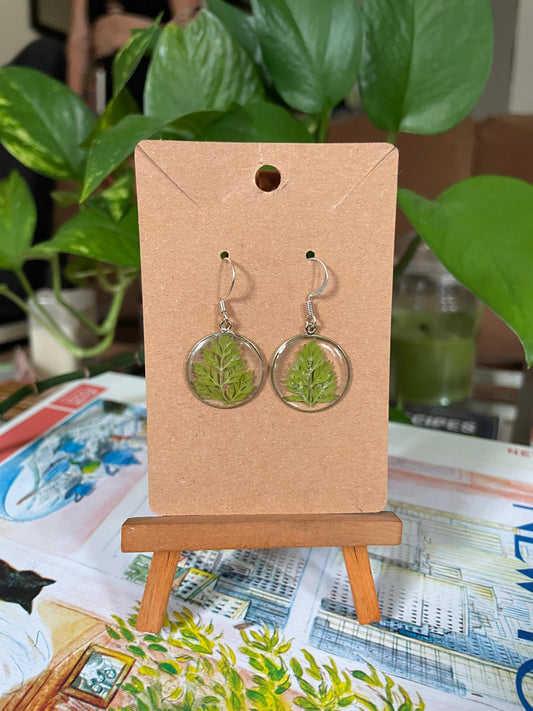Resin circle pendants with green leaves